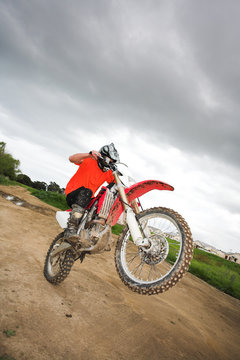 Young Man Riding Around On His Dirtbike Doing Tricks 