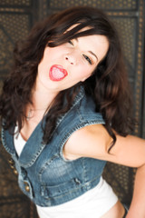 Young adult brunette woman with a white top and brown hair 