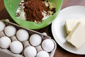 Baking ingredients on table: eggs, butter and flour