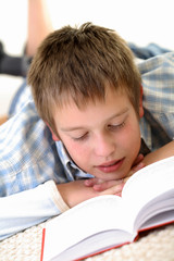 Boy learning on the floor.