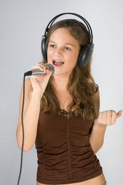 Young pretty girl singing.