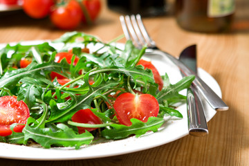 italian salad from tomatoes, rucola, grated parmesan cheese