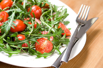 freshly made italian salad from arugula and tomatoes 