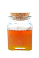 Jar of honey isolated on white background
