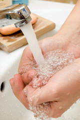 Fototapeta premium woman's hands in waterflow