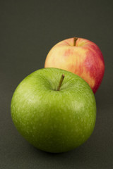 2 pommes vert et rouge isolées sur fond sombre