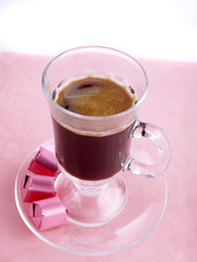 Glass of coffee and chocolate on the pink serviette