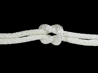 Knot on white rope isolated on black background