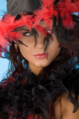young pretty woman in hat with plumage