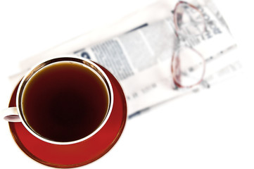 A cup of tea, a newspaper and glasses