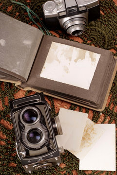 Old vintage photo album and a classic film camera