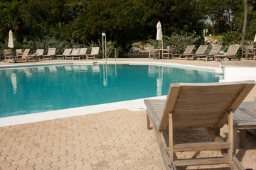 swimming pool with loungers with no people in sight