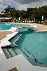 swimming pool with loungers with no people in sight