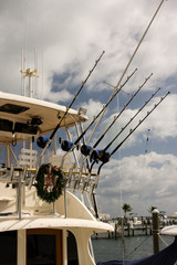 row of fishing rods and reels on sport fishing boat