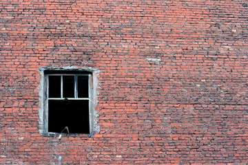 Old urban brick wall with destroyed window.