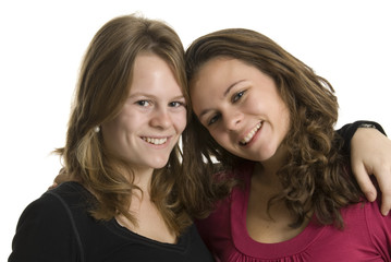 a portrait of two smiling teenage sisters