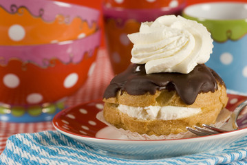 a chocolate eclair with whipped cream