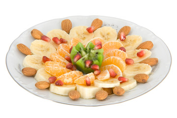 Delicious fruit salad on white round plate isolated on white