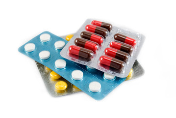 Yellow, white and red - brown tablets are photographed close up