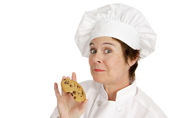 Chef enjoying a delicious fresh baked chocolate chip cookie.