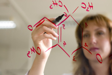 scientist writing a formula