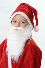 Portrait of a boy in cap Santa and white beard