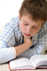 Young boy learning on the floor.