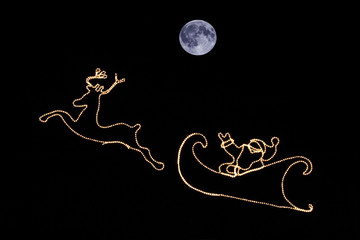 Santa and moon in the sky