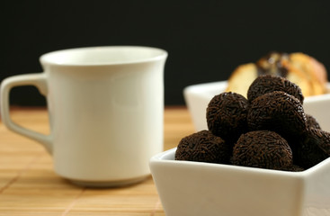 Coffee and chocolate for dessert with a black background