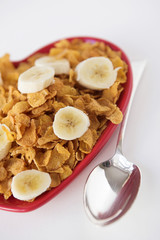 Cornflakes & sliced banana on a heart shaped plate