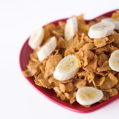 Cornflakes & sliced banana on a heart shaped plate