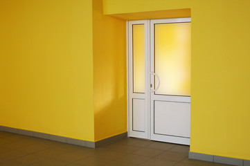 The glazed door in a yellow room