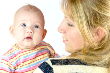 mother holding her baby both wearing stripped closes