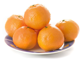 Tangerines on a plate on white background
