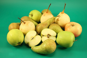 Apples and pears on a green background.