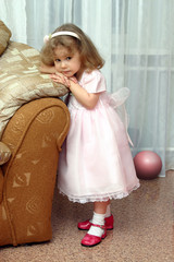 The Portrait of the little preschool girl in pink gown.