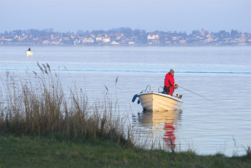Man in fishing-boat sport fishing © mema
