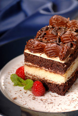 A chocolate layer cake with raspberries and fudge frosting