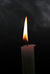 candle with smoke on the isolated black background