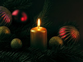 burning candle and Christmas ornaments