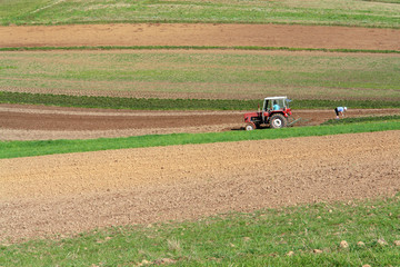 Farm tractor plowing arable field