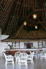 tropical bar in hotel with white wicker chairs