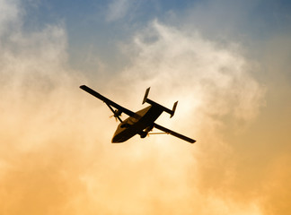 Fototapeta na wymiar Airplane departing at dawn