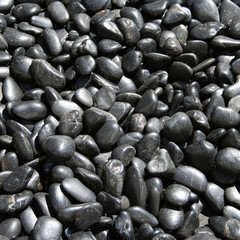 collection of shiny round black pebbles background