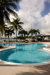 marina swimming pool with blue sun beds and chairs