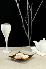 A modern table setting with cookies and tea