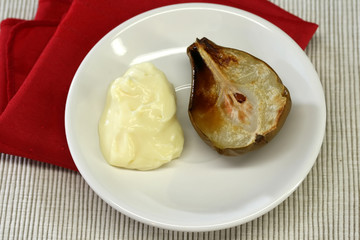 An oven baked pear and custard for dessert