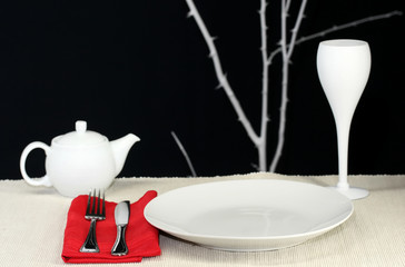 A modern dinner table set for one