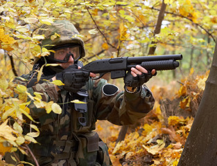 man in uniform holding gun and aiming at a target