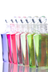 Spa bottles - multi colors - on reflective surface.